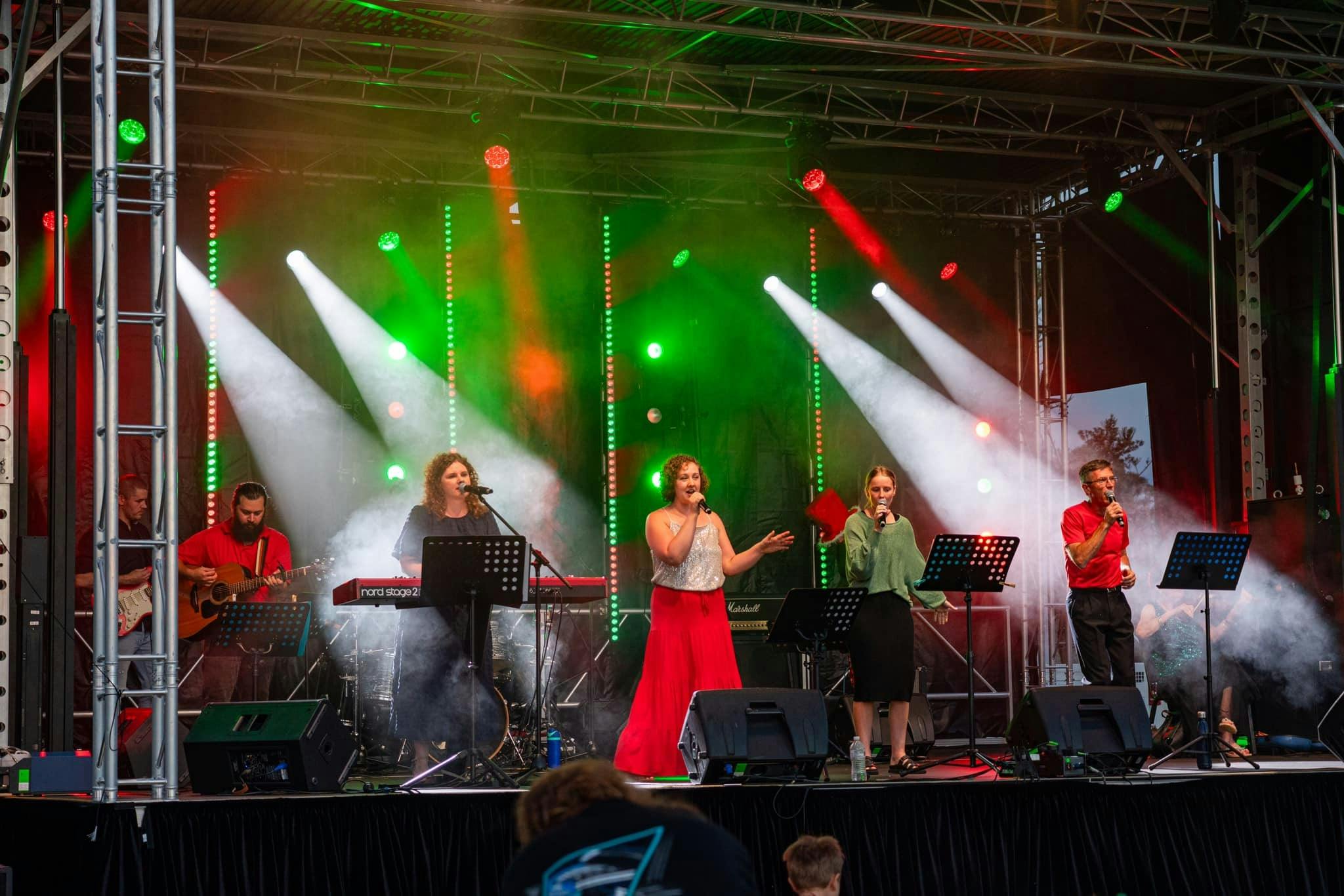 Local musicians singing on the Riverside Carols stage